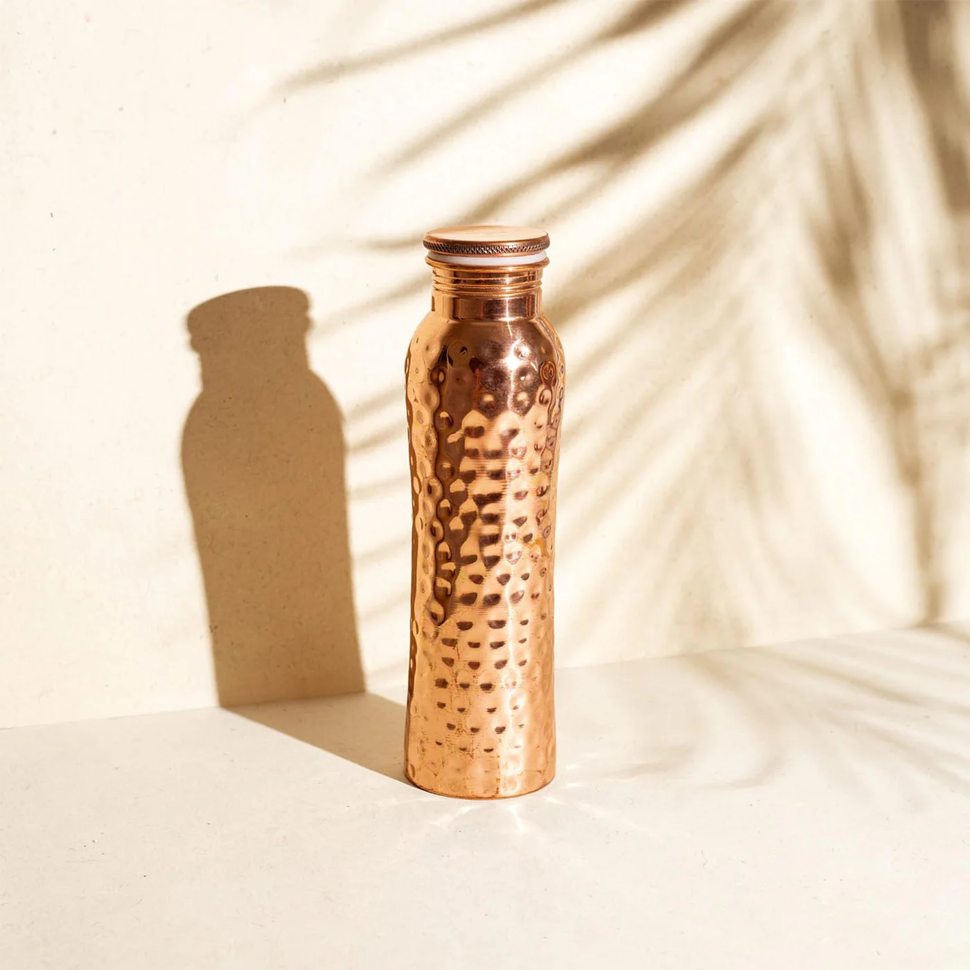 Coppora copper bottle — Hammered finish: The signature — thousands of hand-hammer marks, no two alike.